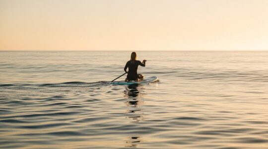 Personne pratiquant un sport nautique en harmonie avec la mer au coucher de soleil